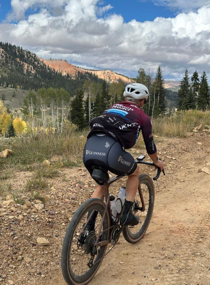 Cyclist on a gravel road in the mountains